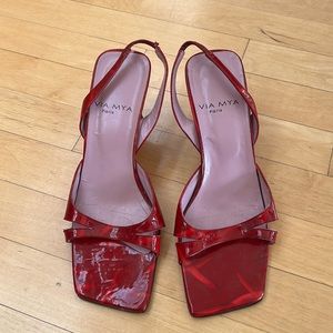 Red patent leather strappy sandals.
